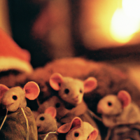 Macro 35mm film photography of a large family of mice wearing hats cozy by the fireplace